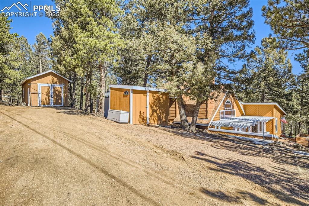 46 Barr Lake Circle Divide, CO 80814 - Photo 3 of 47 a backyard of a house with large trees and plants