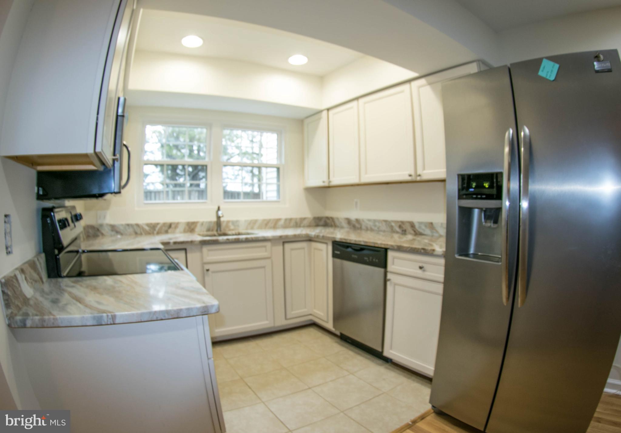 Granite and Stainless Steel Appliances in Kitchen