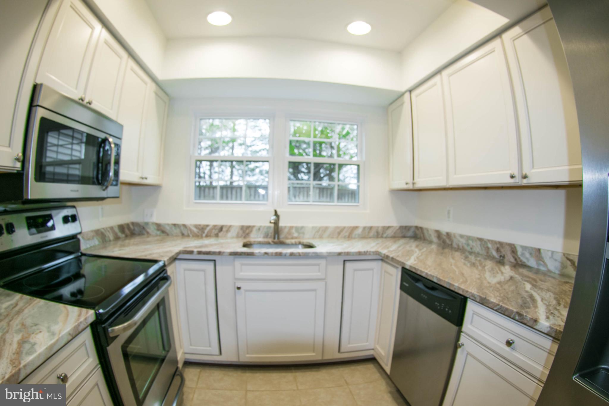 Granite and Stainless Steel Appliances in Kitchen