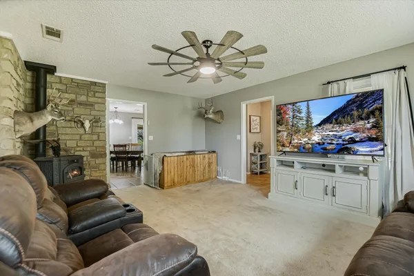a living room with furniture a fireplace and a flat screen tv