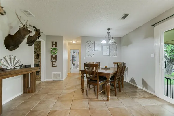 a view of a dining room with furniture and chandelier