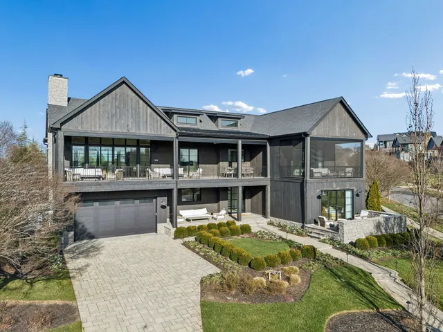 a front view of a house with a yard table and chairs