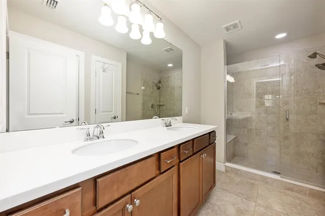a bathroom with a sink double vanity and a mirror