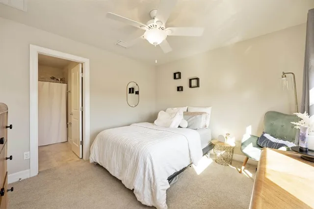 a bedroom with a bed and ceiling fan