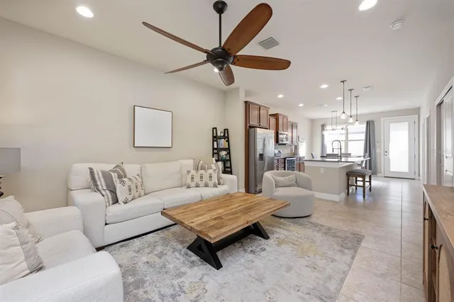 a living room with furniture and a chandelier