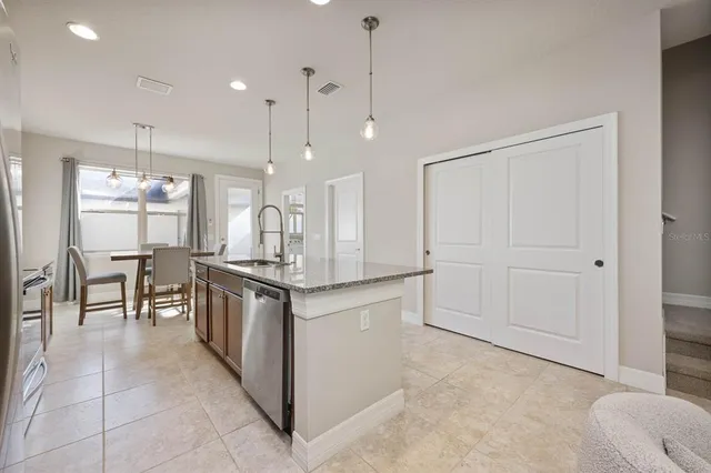 a kitchen with stainless steel appliances granite countertop a refrigerator and a sink