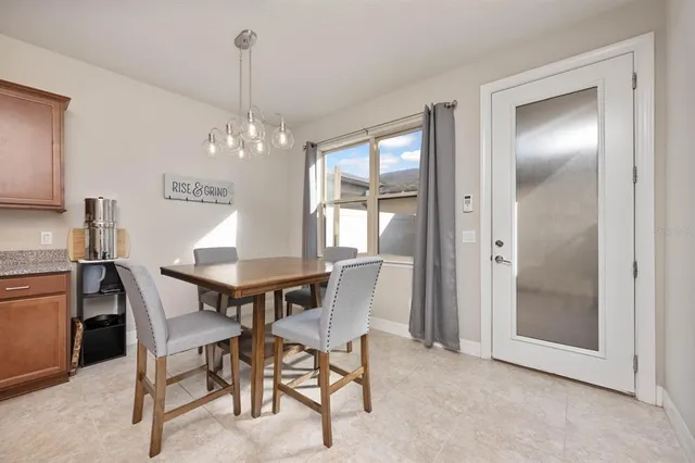 a view of a dining room with furniture and chandelier