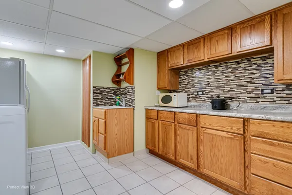 a kitchen with stainless steel appliances a refrigerator and cabinets