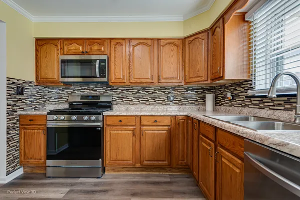 a kitchen with stainless steel appliances granite countertop a stove microwave and sink