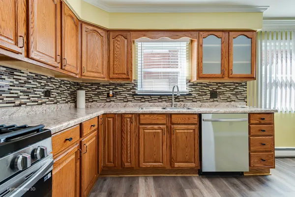 a kitchen with stainless steel appliances granite countertop a stove a sink and a microwave