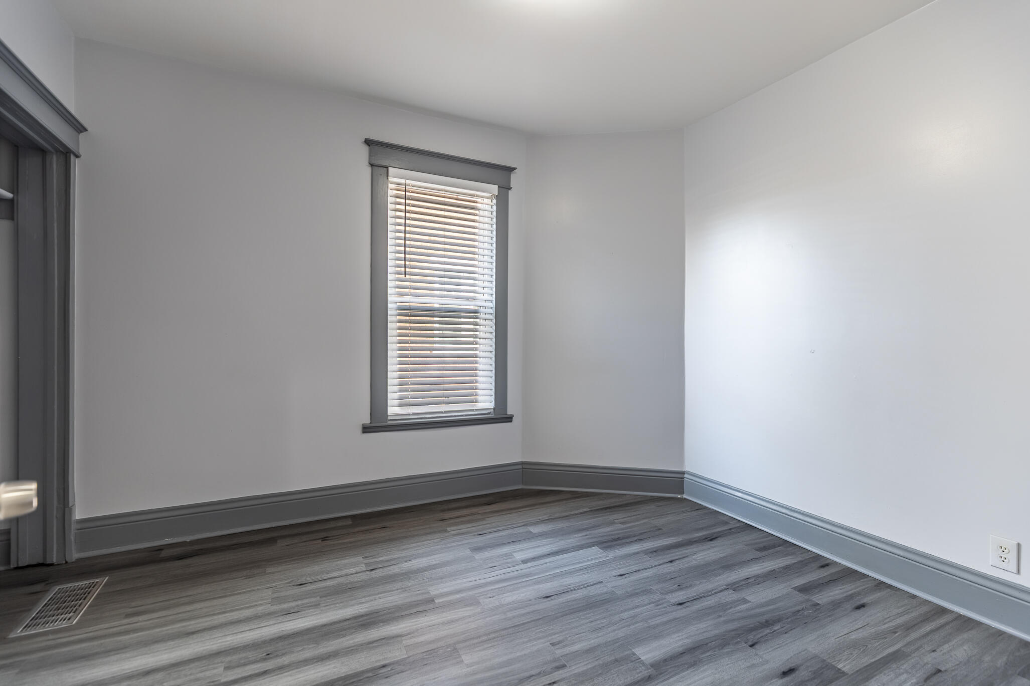 23 Mason Street Hammond, IN 46320 - Photo 17 of 62 an empty room with wooden floor and windows