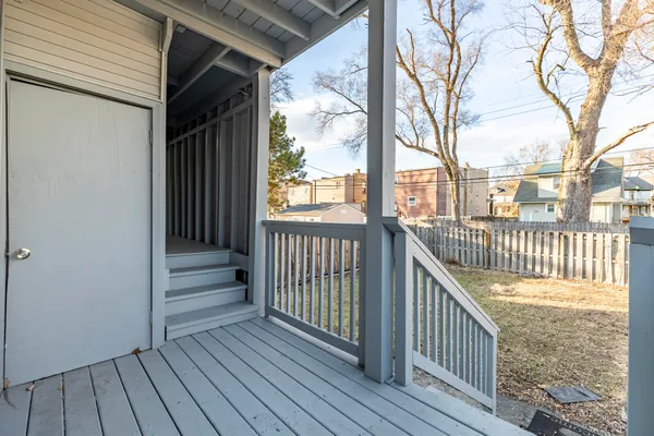 a view of a livingroom with wooden floor and a ceiling fan