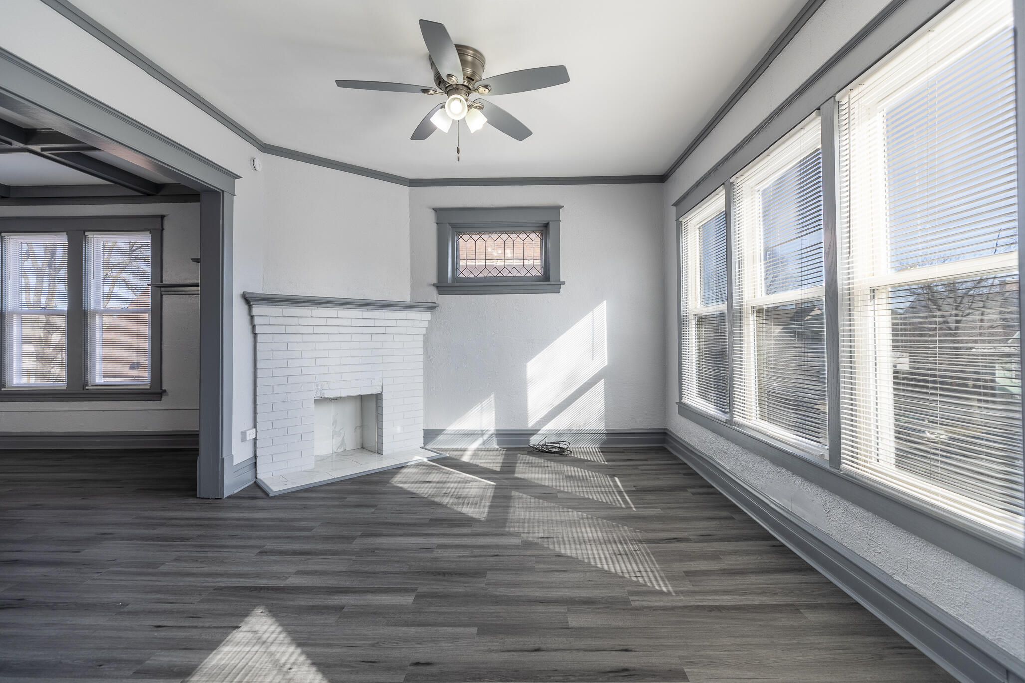 23 Mason Street Hammond, IN 46320 - Photo 28 of 62 a view of a livingroom with wooden floor and a ceiling fan