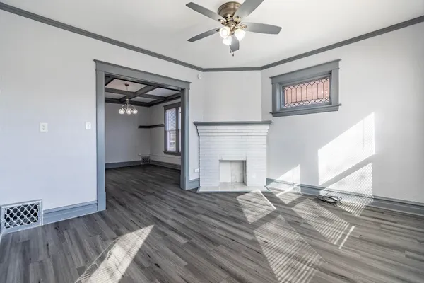 a view of a small space with wooden floor and a window