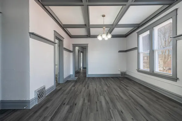 a view of a hallway with wooden floor and entryway