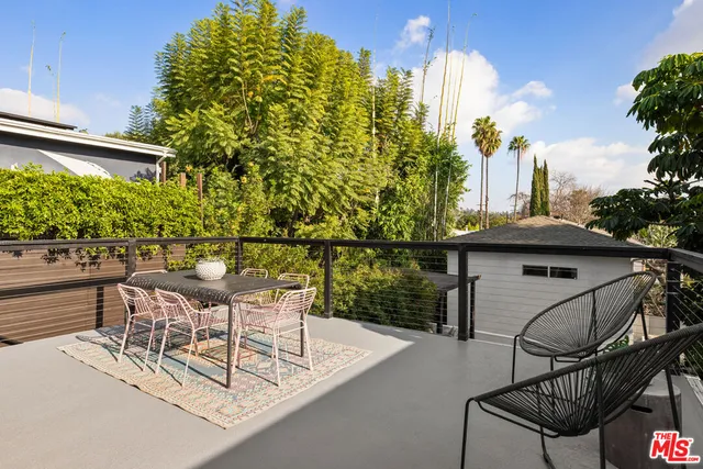 a view of a chairs and table in patio