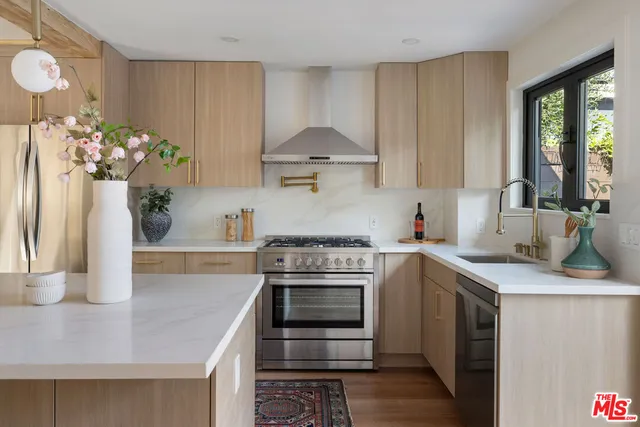 a kitchen with a sink stove and cabinets