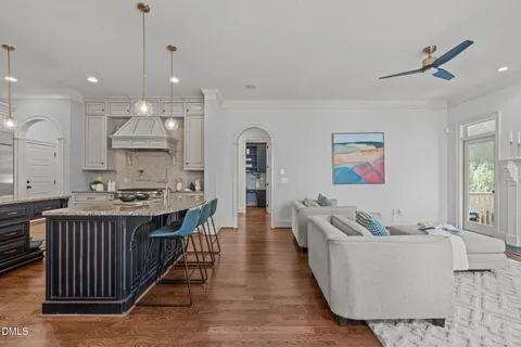 a kitchen with granite countertop a sink stove and cabinets