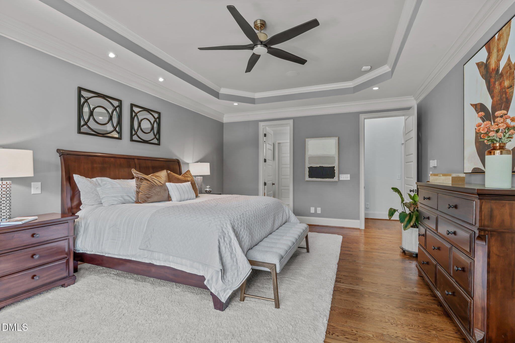 3005 Greyhawk Place Apex, NC 27539 - Photo 43 of 88 a spacious bedroom with a bed and a chandelier