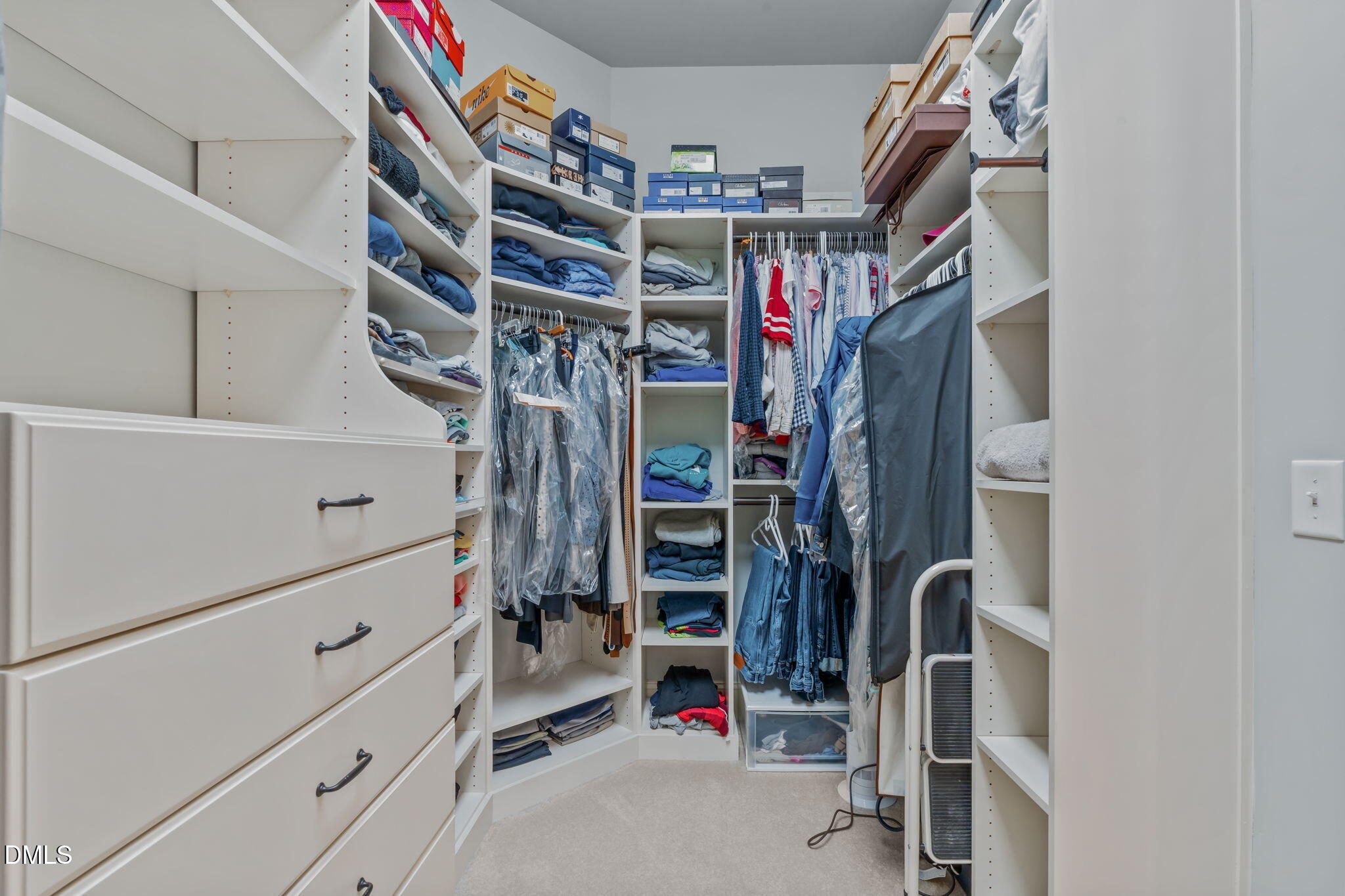 3005 Greyhawk Place Apex, NC 27539 - Photo 48 of 88 a view of walk in closet with clothes and shoes