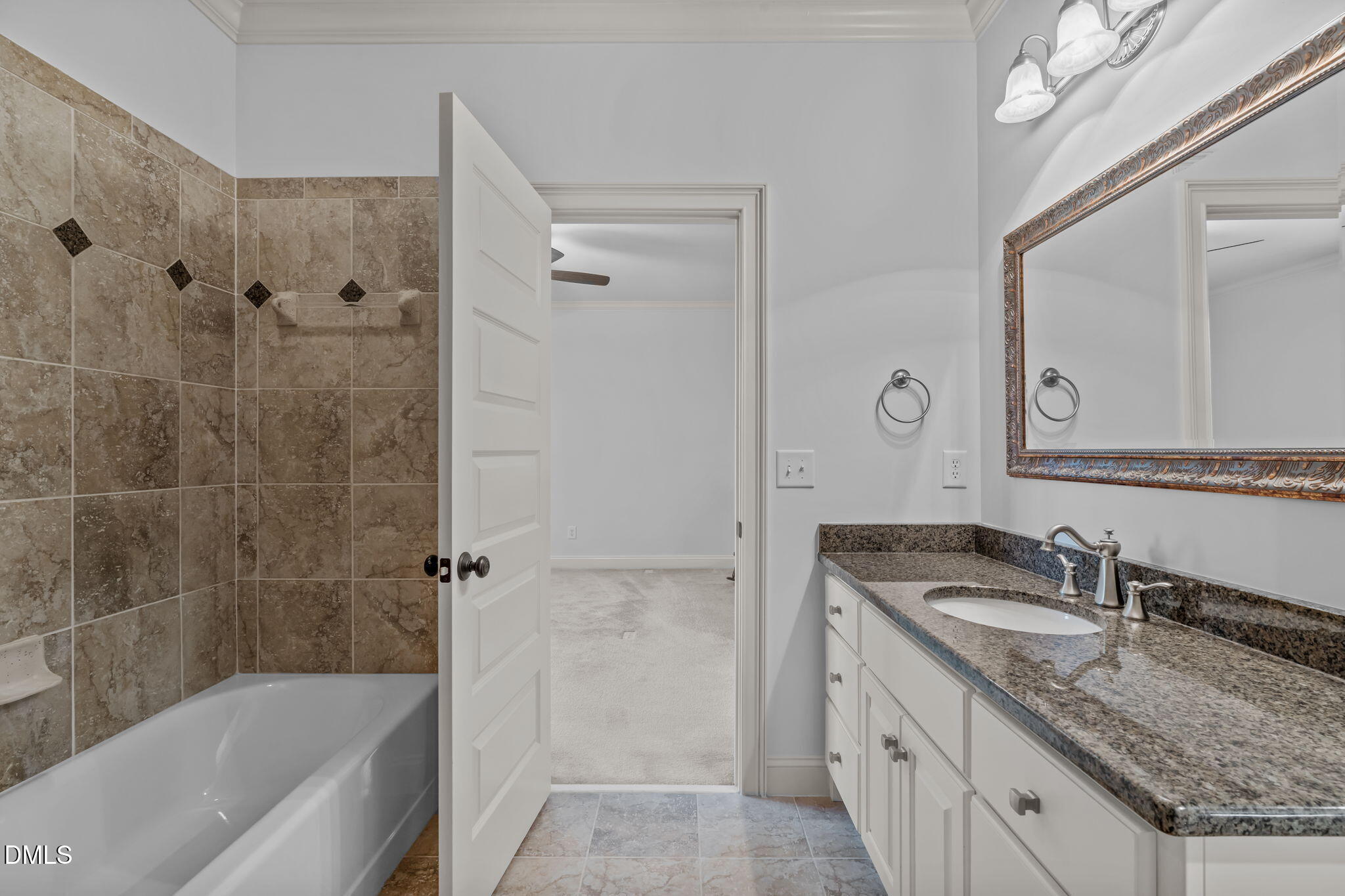 3005 Greyhawk Place Apex, NC 27539 - Photo 62 of 88 a bathroom with a granite countertop sink a mirror a bathtub and shower