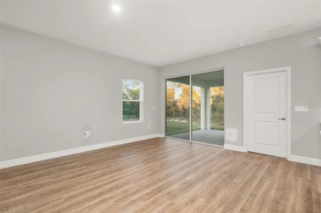 a kitchen with stainless steel appliances white cabinets a stove a refrigerator and a microwave