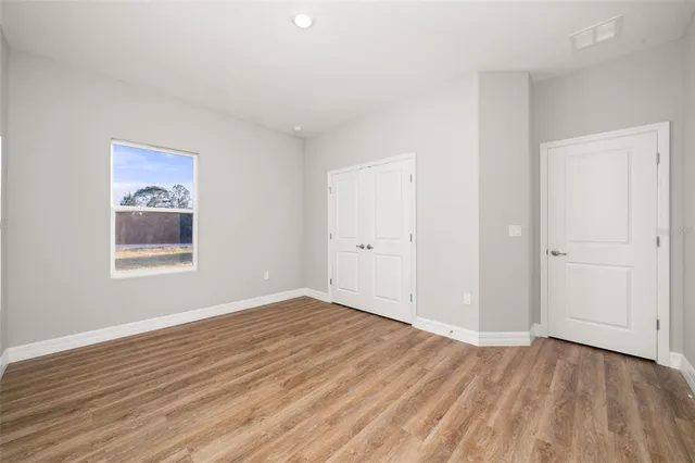 a bedroom with a large bed and a window