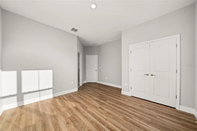 a view of room with window and wooden floor