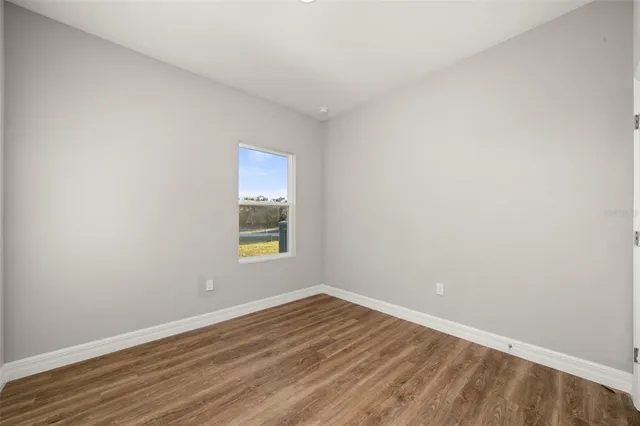 a bathroom with a granite countertop sink a toilet and a mirror