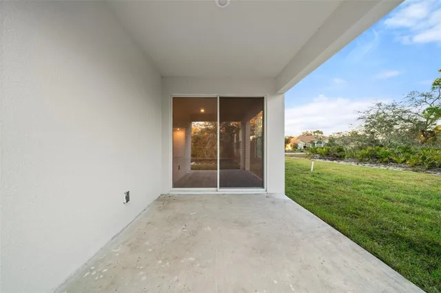 a living room with white couches and a dining table with kitchen view