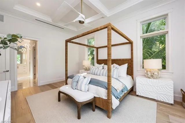 a spacious bedroom with a bed and a large window