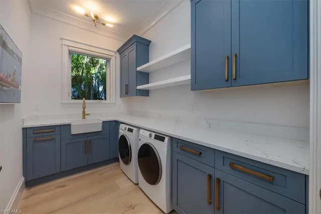 a utility room with cabinets washer and dryer