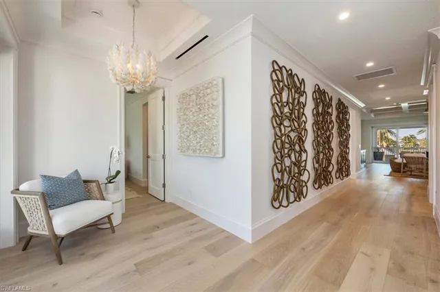 a view of a livingroom with furniture wooden floor and a chandelier