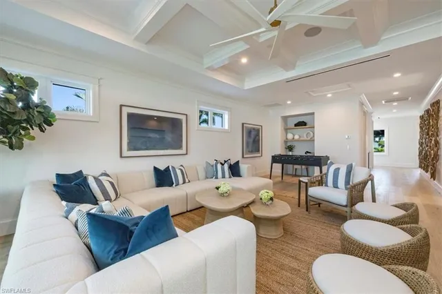 a living room with furniture and a large mirror