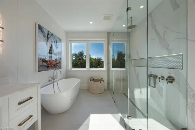 a spacious bathroom with a bathtub and shower