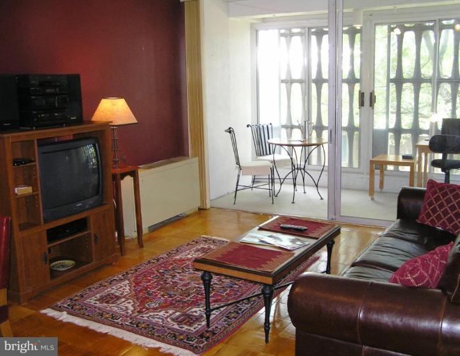 1311 Delaware Avenue Southwest, Unit S147 Washington, DC 20024 - Photo 1 of 18 a living room with furniture and a wooden floor