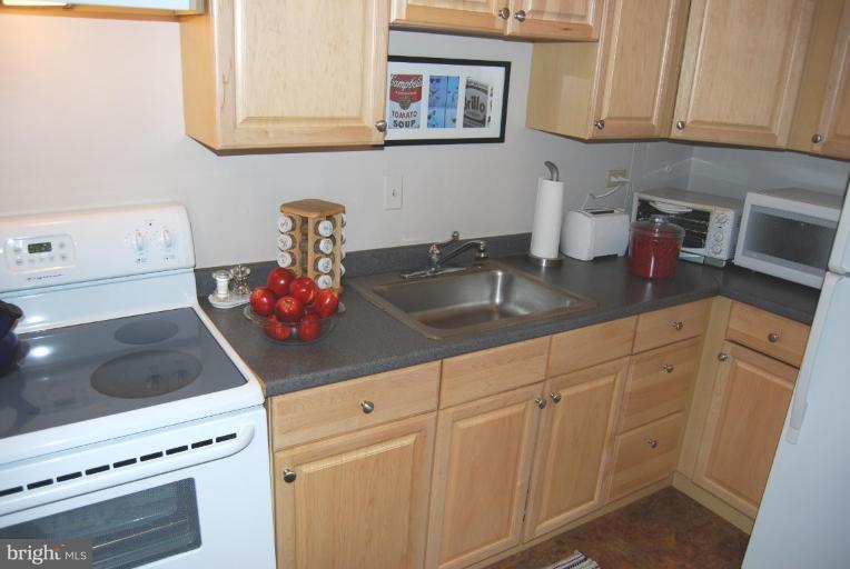 1311 Delaware Avenue Southwest, Unit S147 Washington, DC 20024 - Photo 7 of 18 a kitchen with white cabinets and white appliances
