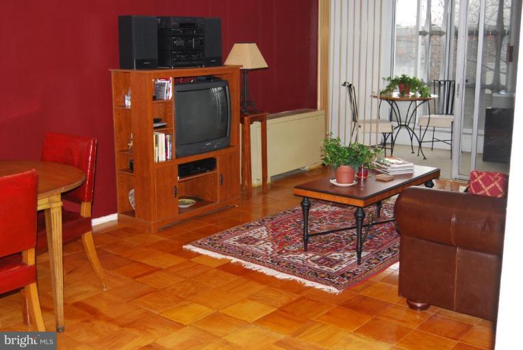 1311 Delaware Avenue Southwest, Unit S147 Washington, DC 20024 - Photo 9 of 18 a living room with furniture a dining table and a refrigerator