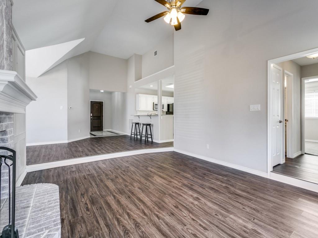 10 Sundance Court Trophy Club, TX 76262 - Photo 1 of 1 a view of a livingroom with wooden floor a ceiling fan and staircase