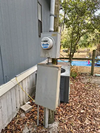 a view of a pathway of a house with wooden fence