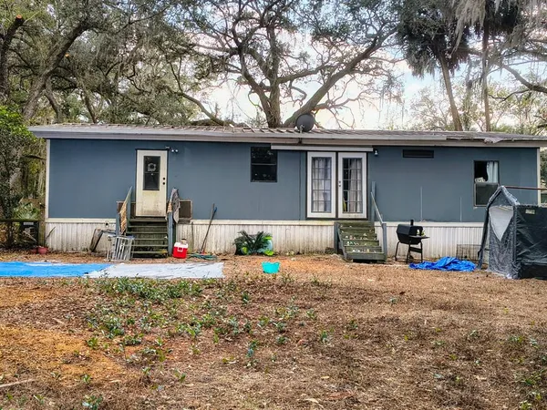 a view of a house with a patio and a yard