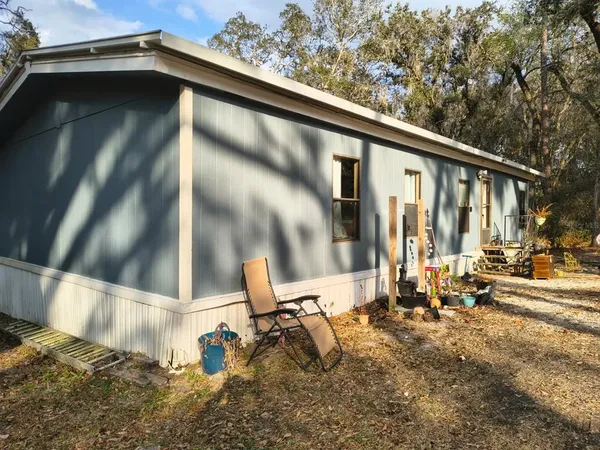 a backyard of a house with table and chairs