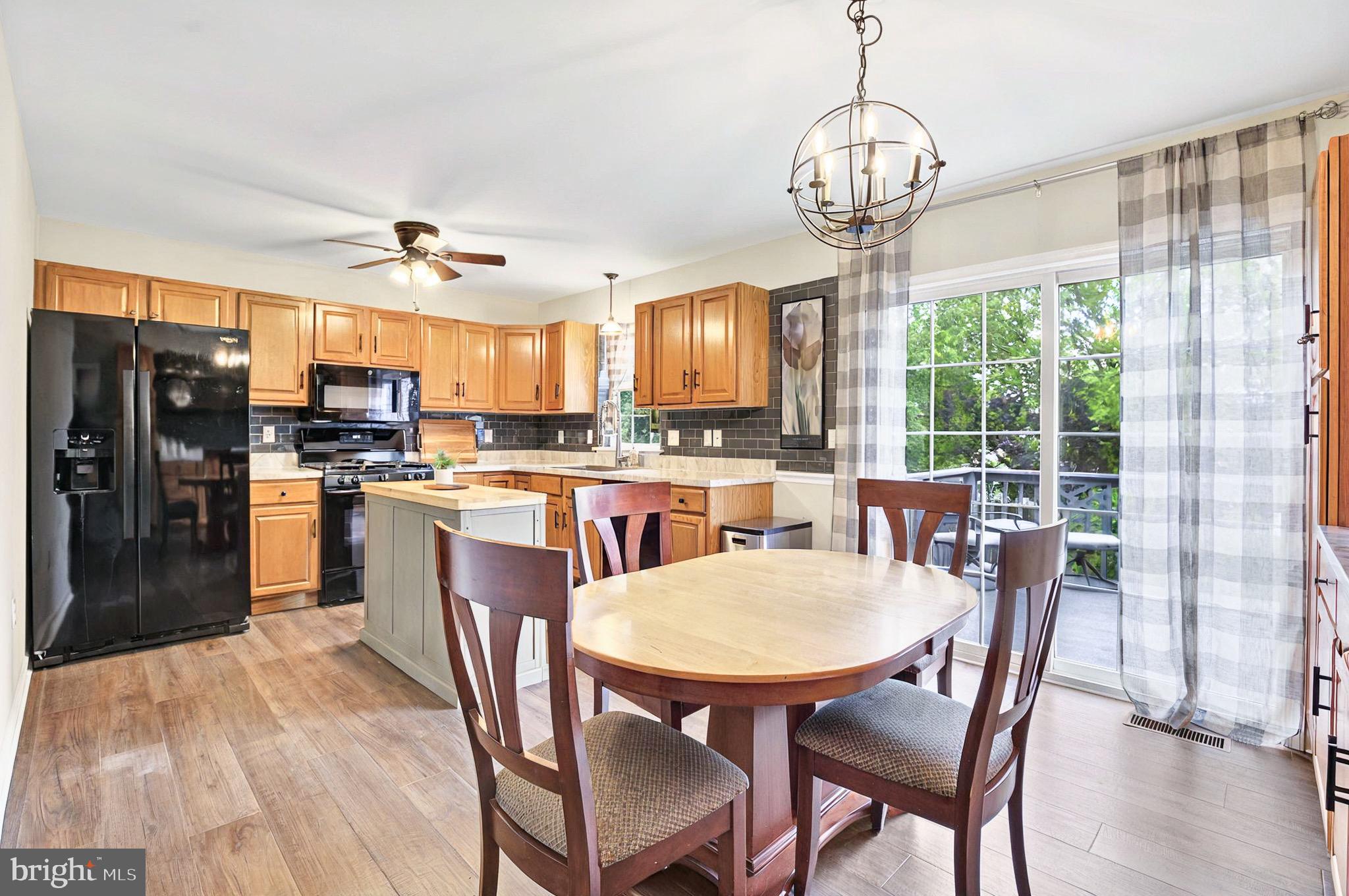20 Pebble Creek Drive Lititz, PA 17543 - Photo 12 of 45 a kitchen with stainless steel appliances granite countertop a stove a refrigerator a kitchen island a dining table and chairs