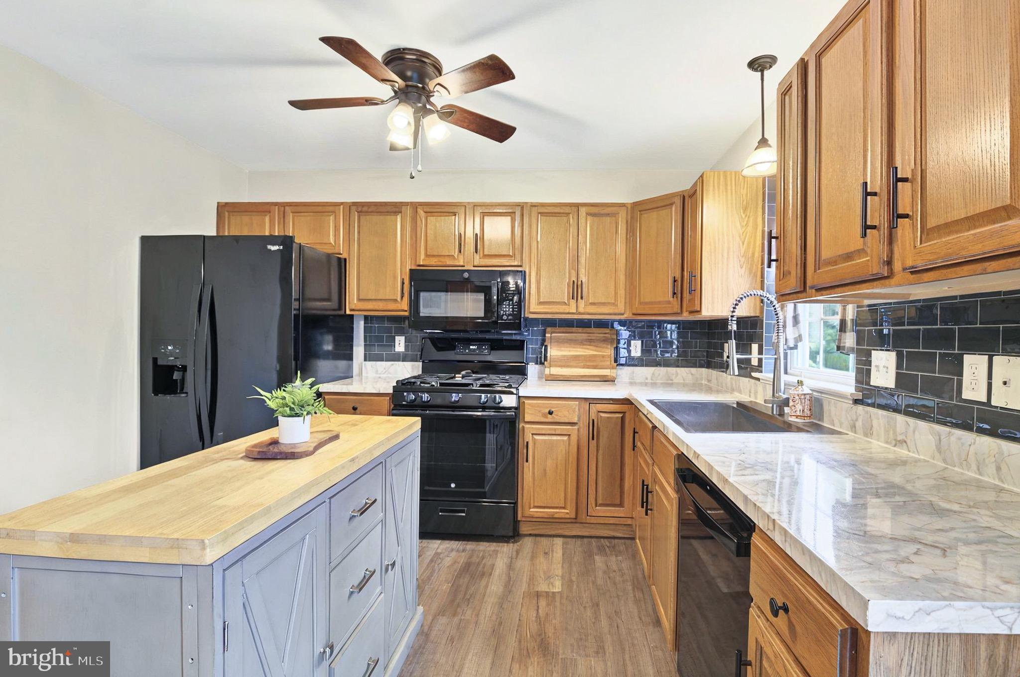 20 Pebble Creek Drive Lititz, PA 17543 - Photo 14 of 45 a kitchen with stainless steel appliances a sink a stove a refrigerator cabinets and living room view