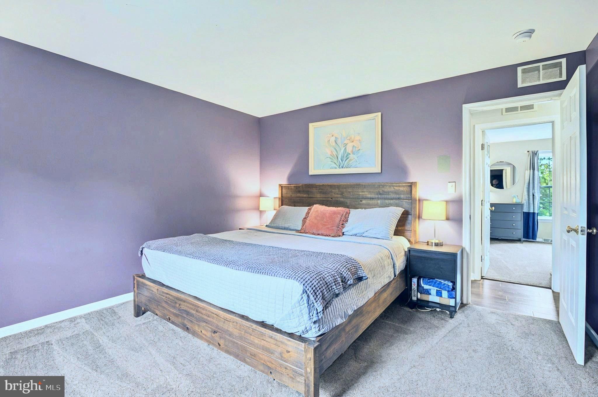 20 Pebble Creek Drive Lititz, PA 17543 - Photo 17 of 45 a bedroom with a bed lamp and a potted plant