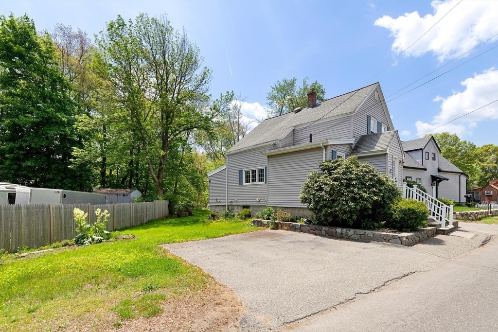 19 Butler Avenue Wakefield, MA 01880 - Photo 3 of 33 a view of a house with a yard and a large tree