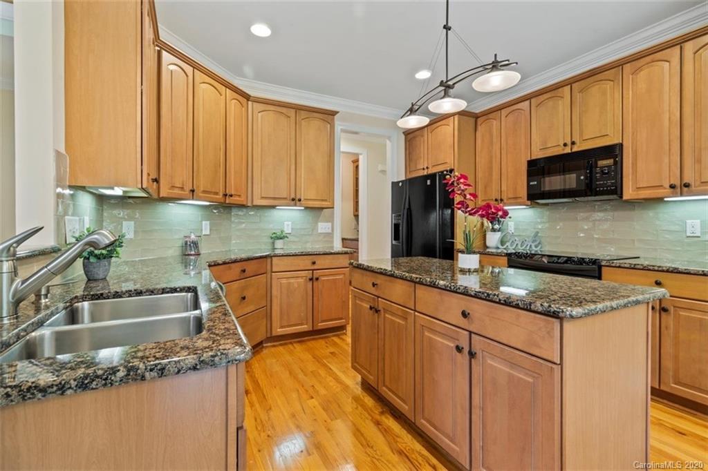 142 Spring Branch Road Fort Mill, SC 29715 - Photo 11 of 48 a kitchen with granite countertop a sink a counter top space appliances and cabinets