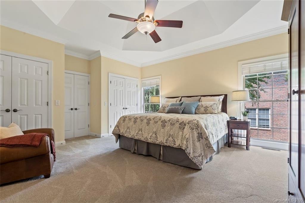 142 Spring Branch Road Fort Mill, SC 29715 - Photo 19 of 48 a spacious bedroom with a bed and a chandelier