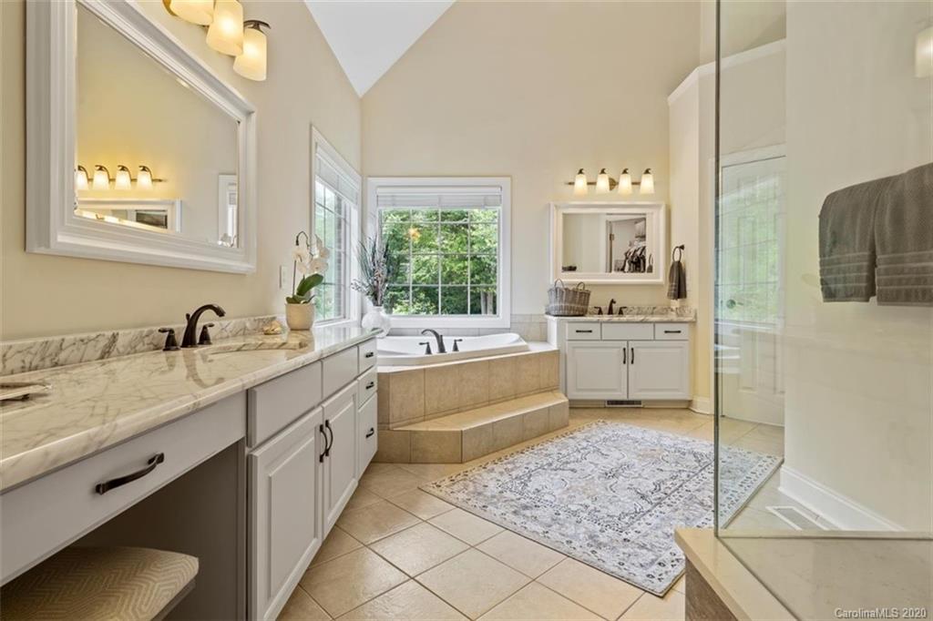 142 Spring Branch Road Fort Mill, SC 29715 - Photo 20 of 48 a large bathroom with a double vanity sink a mirror and a bathtub
