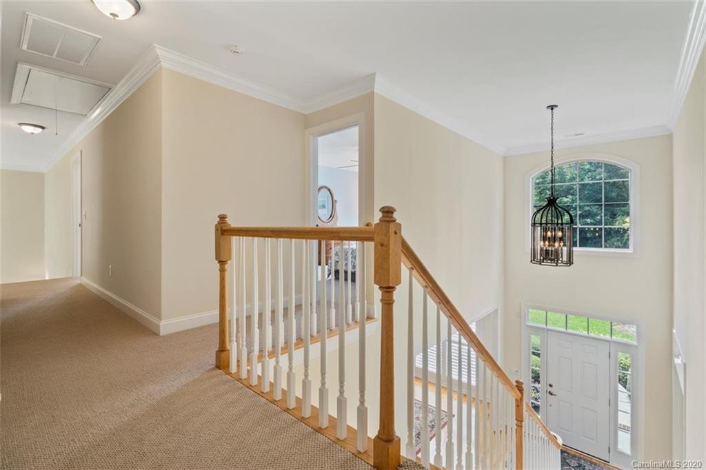 142 Spring Branch Road Fort Mill, SC 29715 - Photo 25 of 48 a view of a hallway with stairs and chandelier